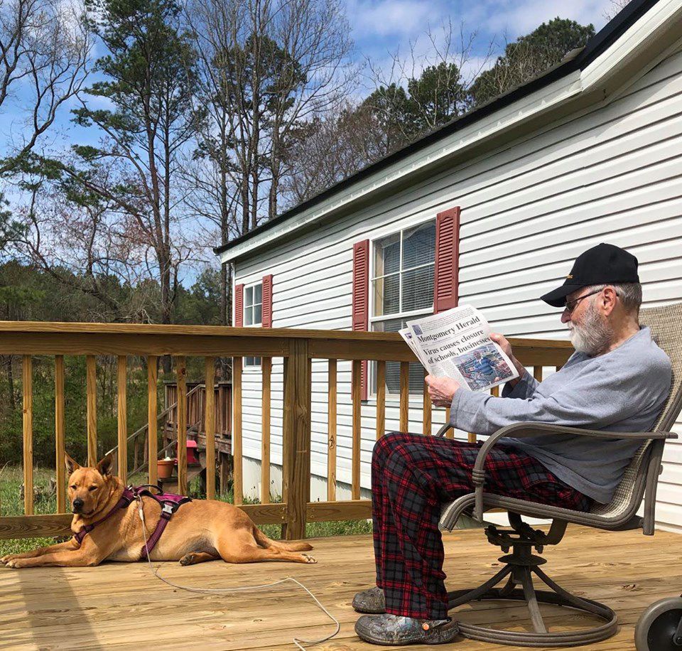 A MAN, HIS DOG AND HIS NEWSPAPER -